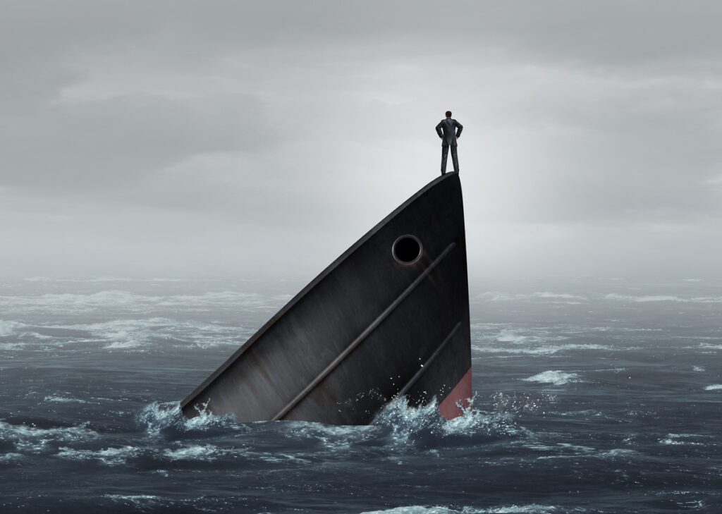 Man stands on sinking ship in gloomy ocean - Executive Leadership Coach Business Career in Pennsylvania Donna Spina Coaching InDeed